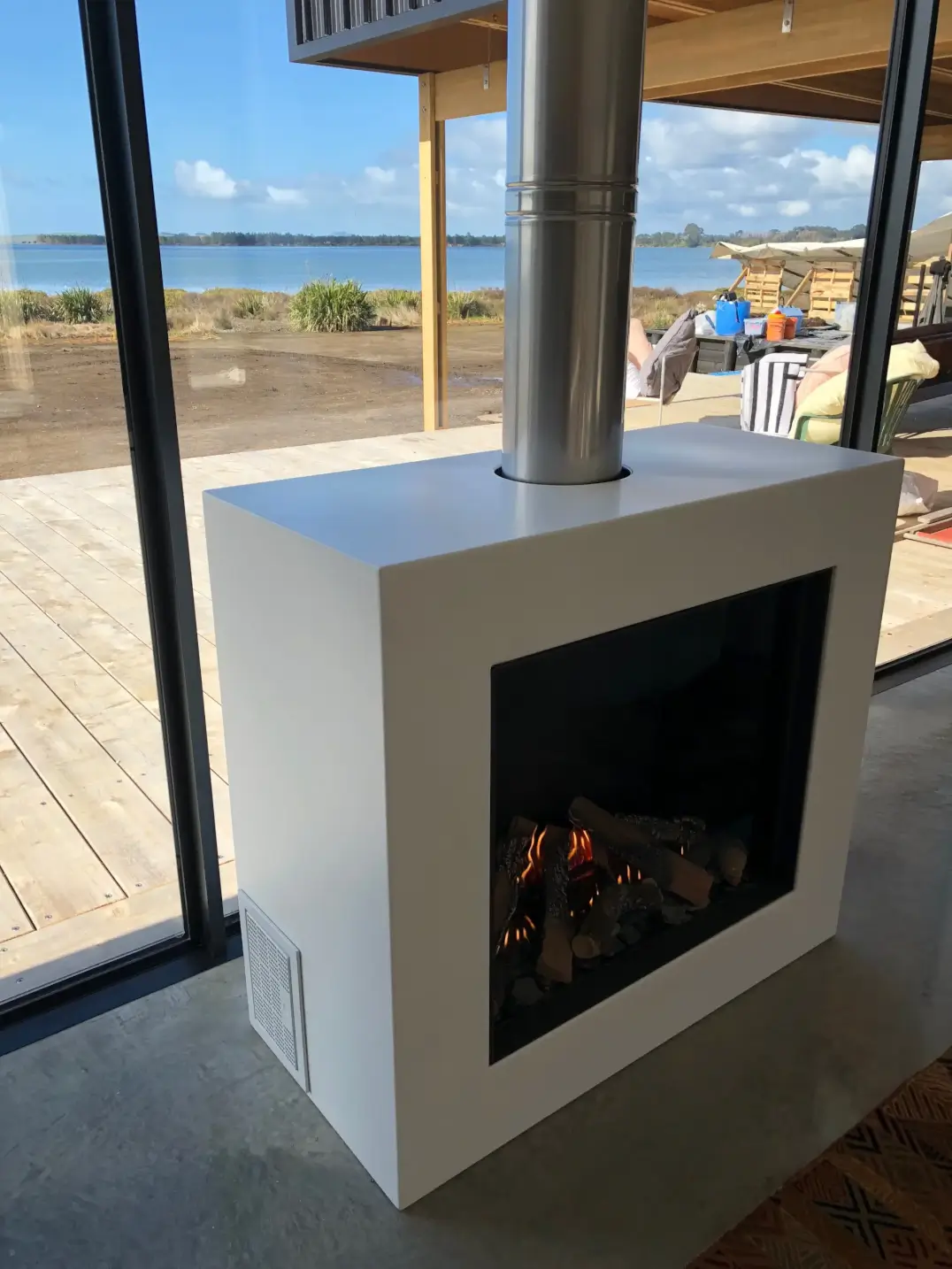 Stainless steel fireplace flue with waterfront view