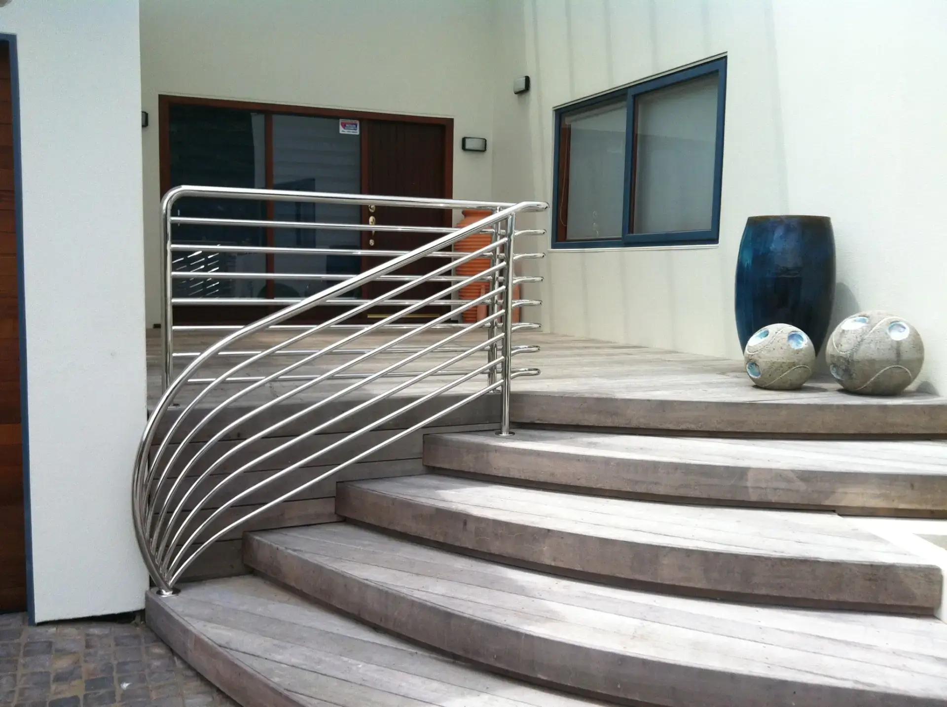 Curved stainless steel balustrade on residential exterior steps