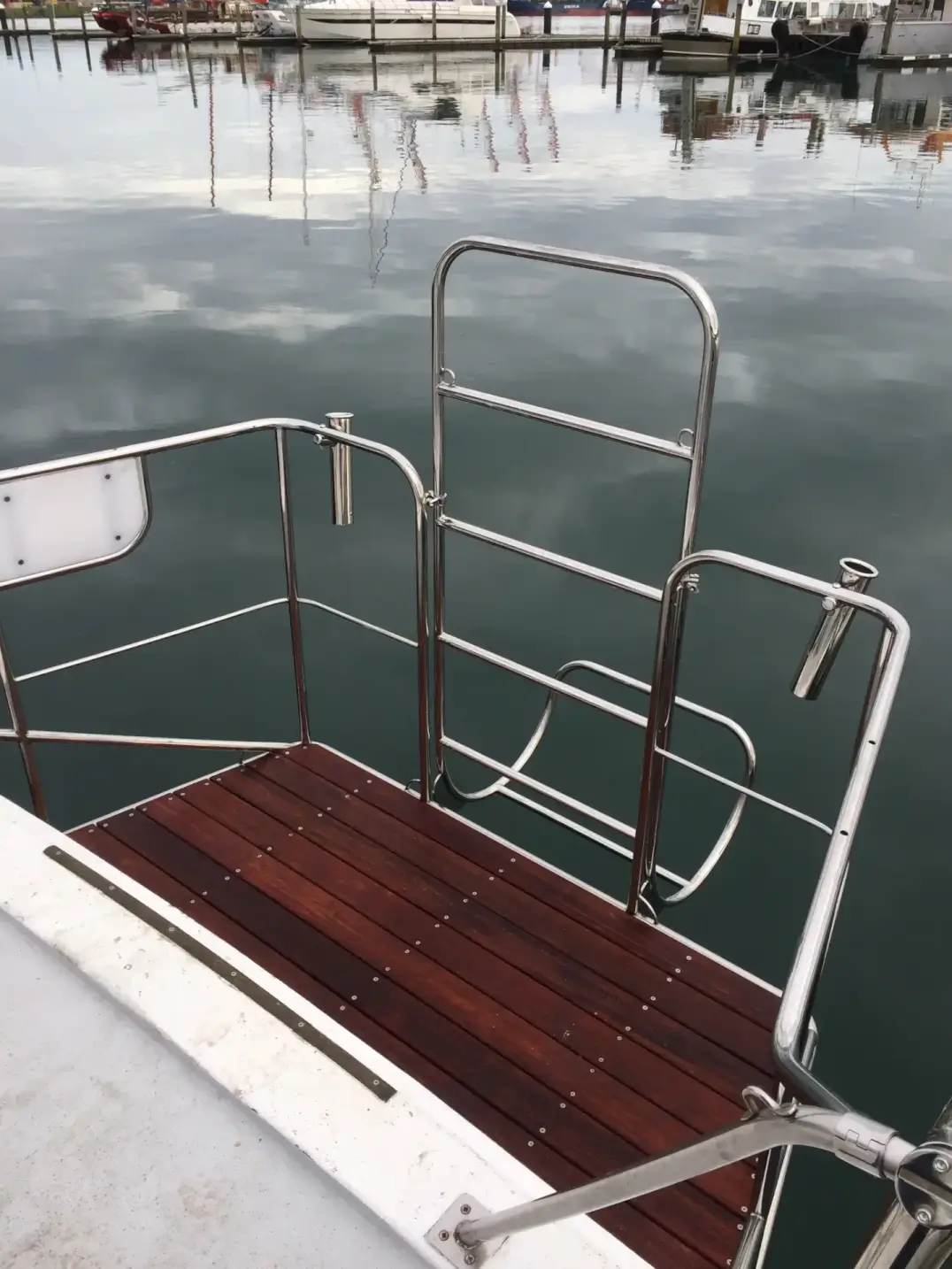 Stainless steel boat boarding ladder with teak platform