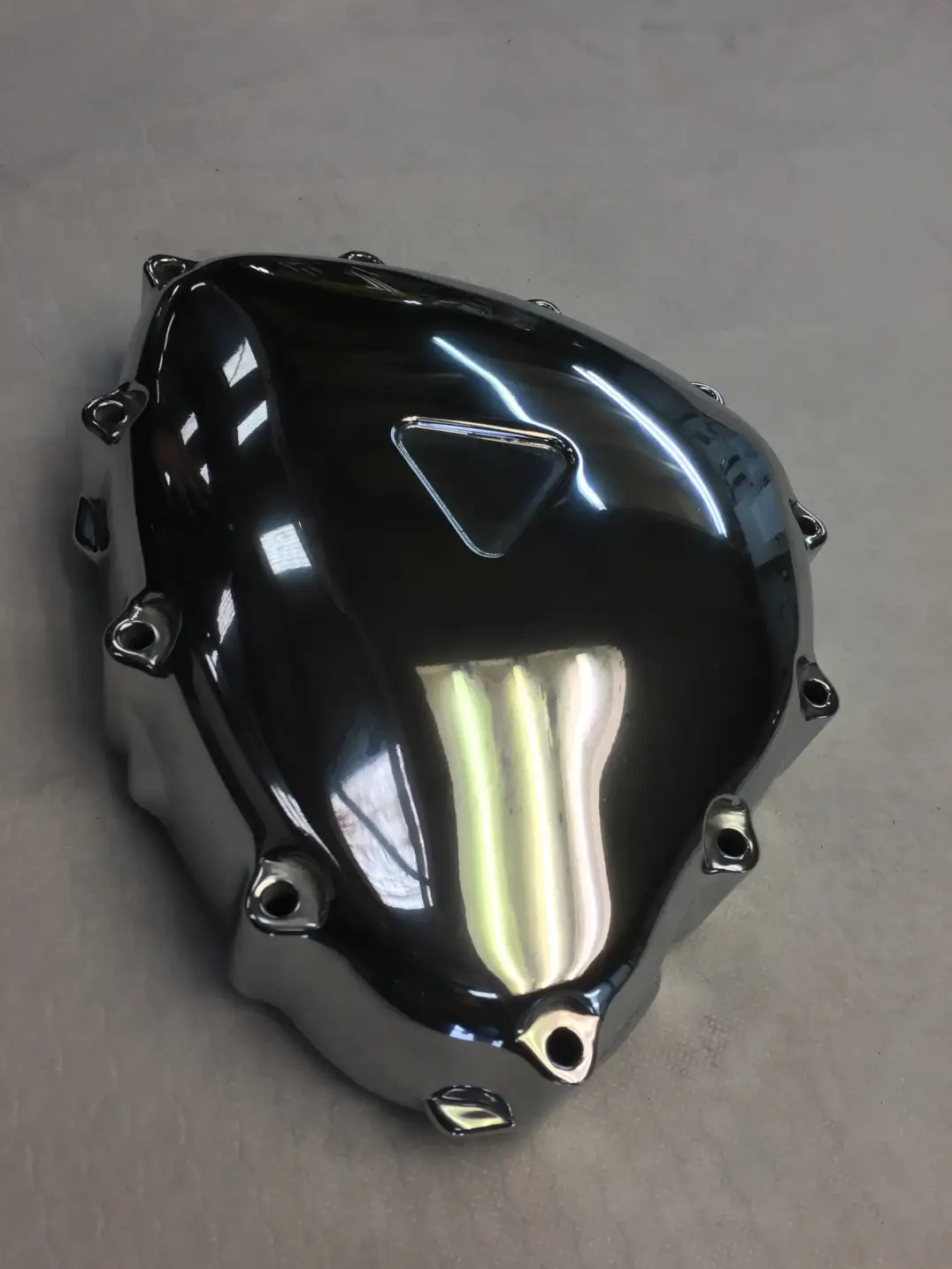 Polished motorcycle engine cover with custom fabrication