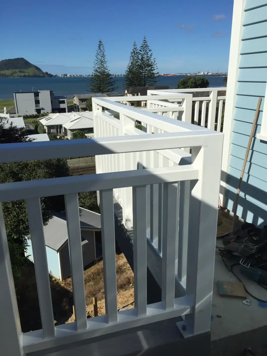 White painted deck balustrade with waterfront views