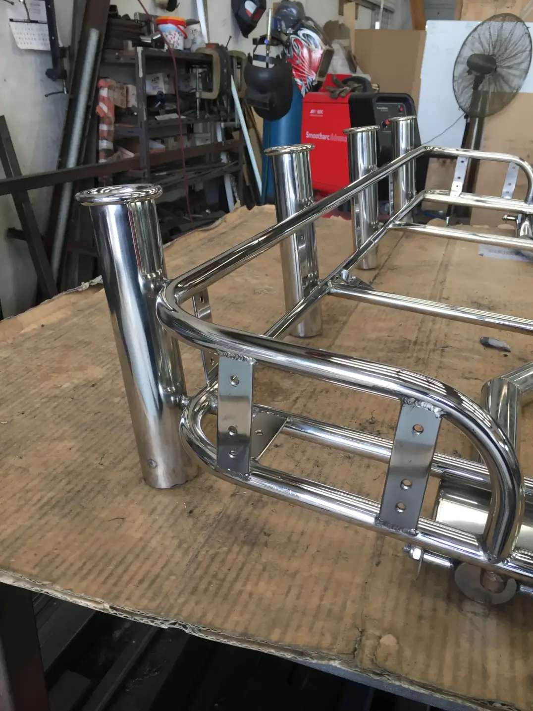Polished stainless steel boat rod holders in workshop