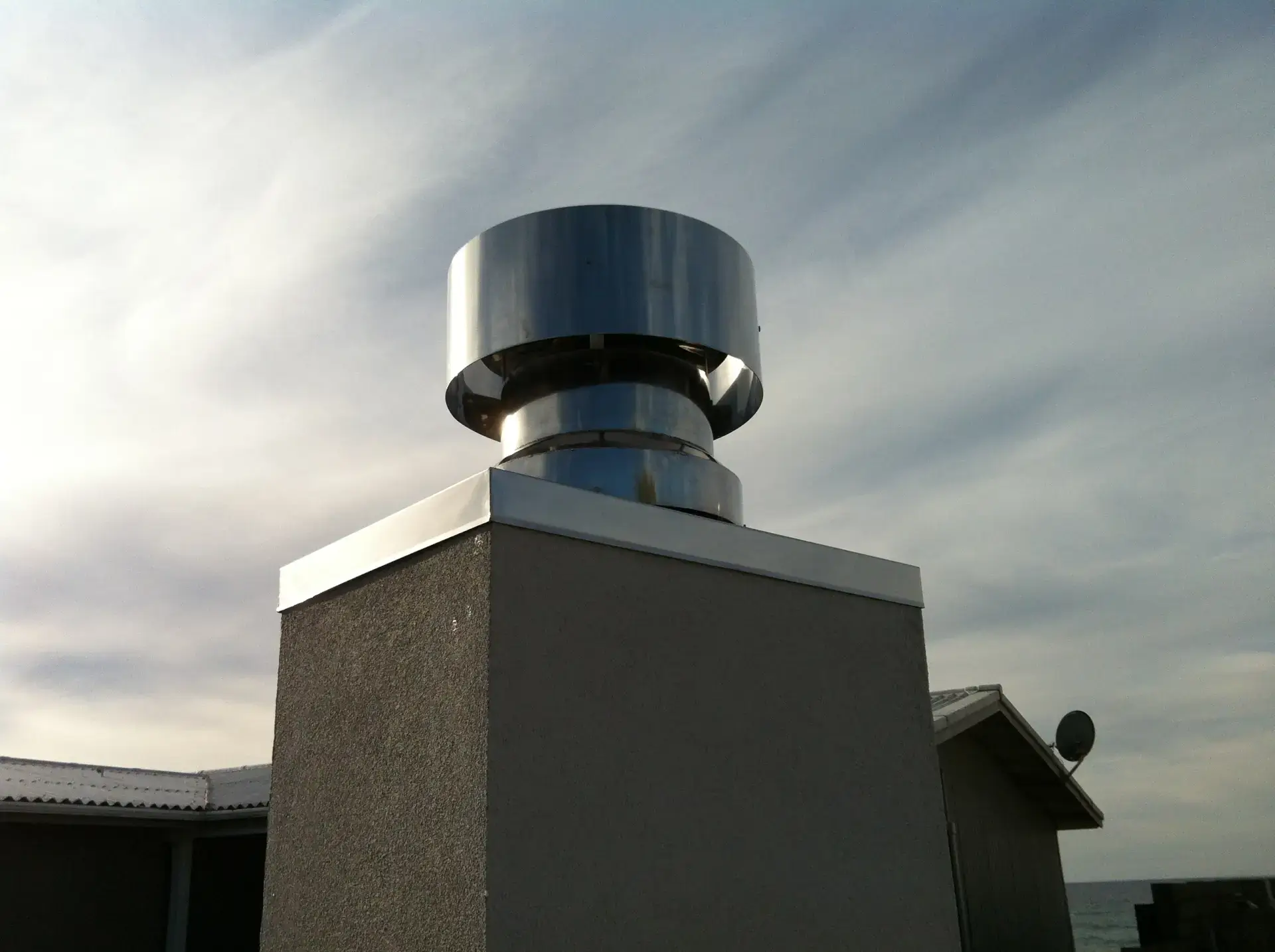 Stainless steel chimney cap with wind cowl