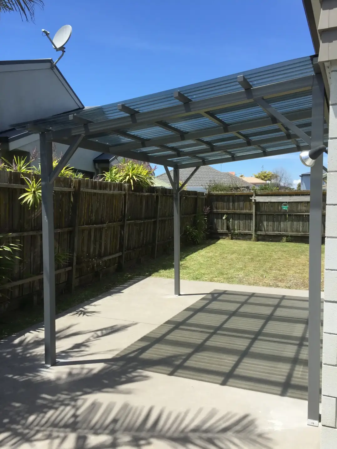 Steel frame pergola with polycarbonate roofing panels