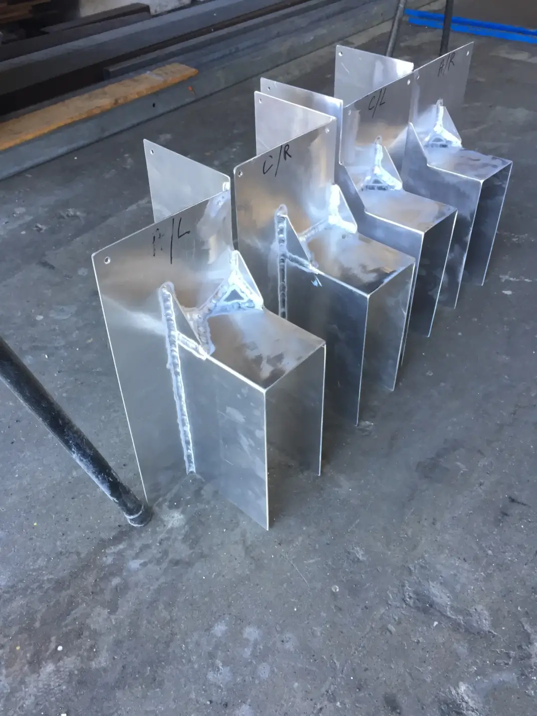 Welded stainless steel bracket assemblies in workshop