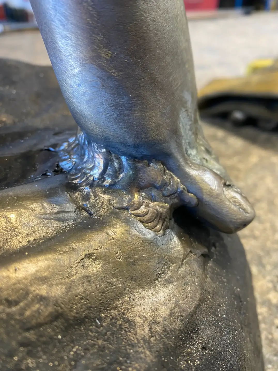 Detailed stainless steel sculpture base weld joint
